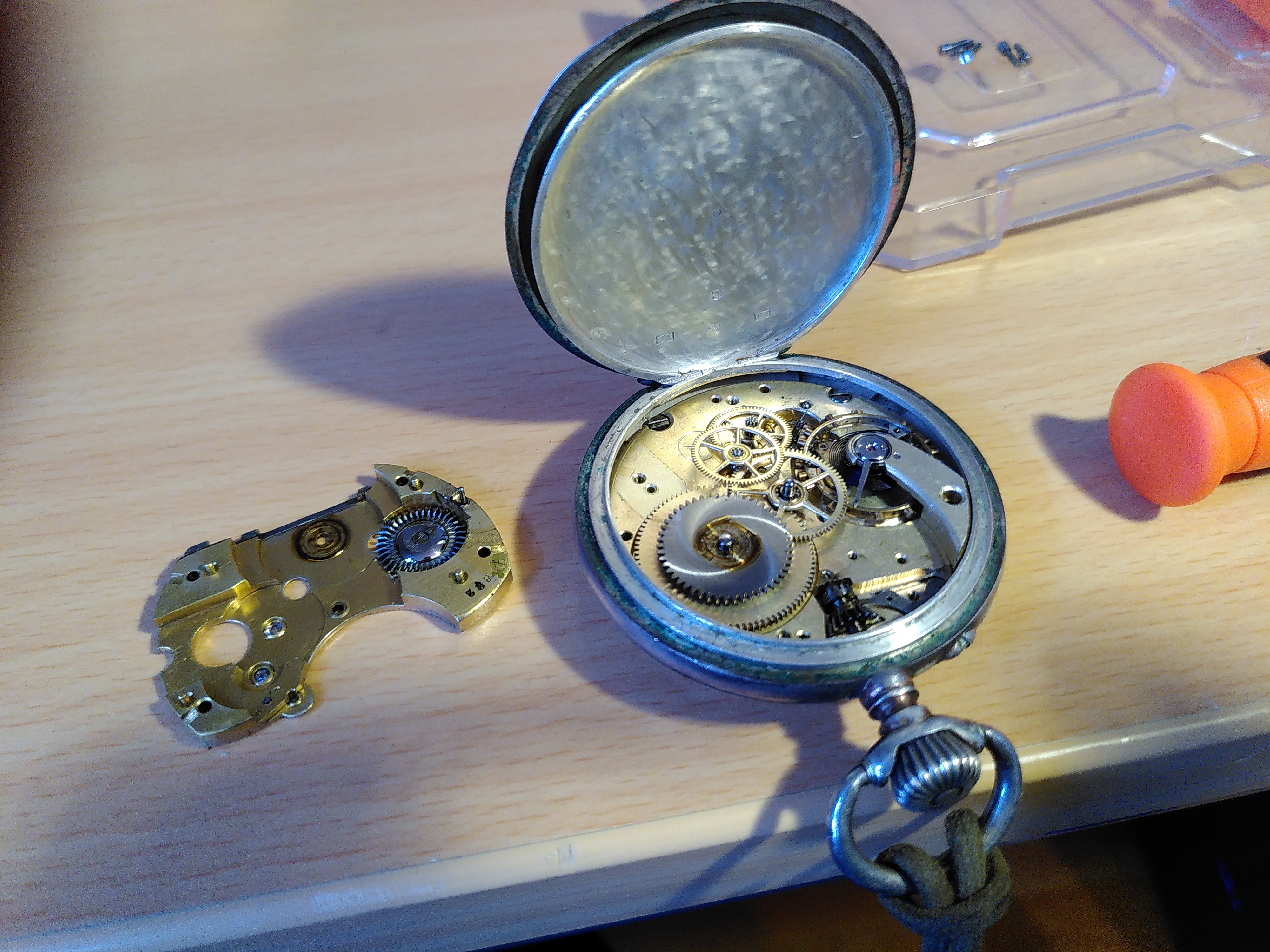 open pocket watch with many intricate gears visible